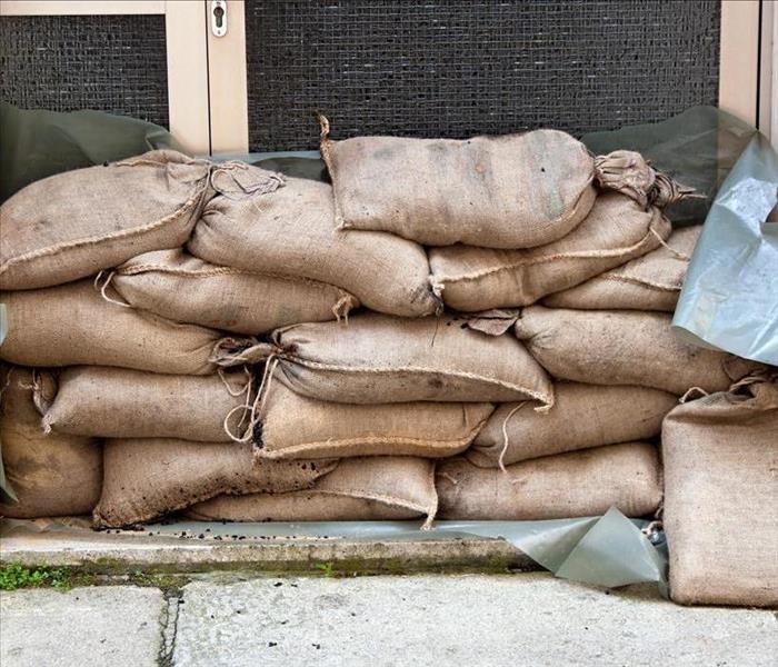 Image of sandbags placed on door to block water from entering a building. 